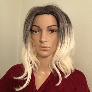 BLONDE WIG WITH DARK ROOTS.